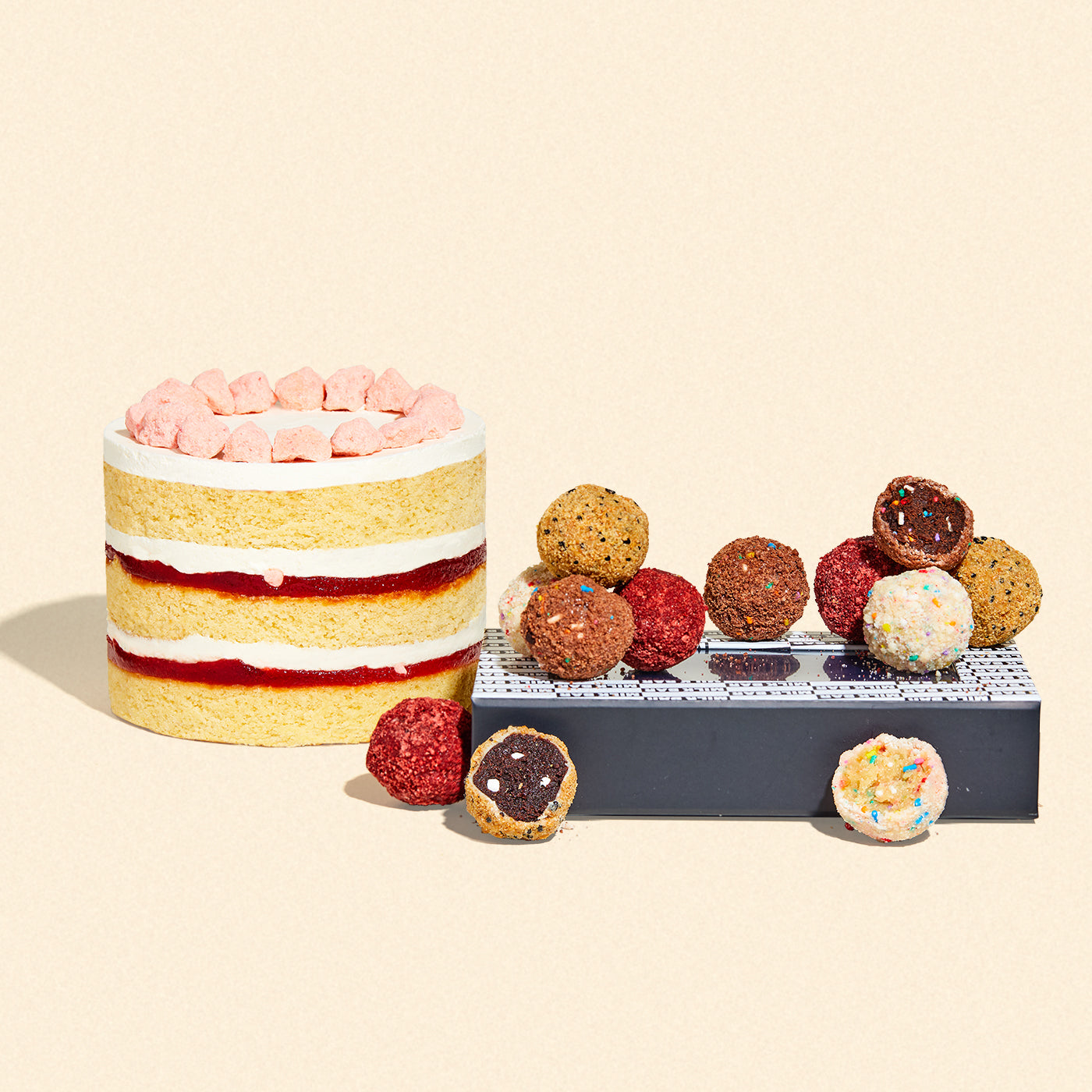 a side view of the limited-time 6 inch strawberry shortcake cake beside a dozen gift box of assorted truffles.