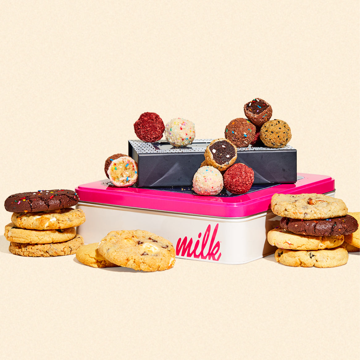 A dozen tin of our 4 most popular cookie flavors with a dozen assorted cake truffle box sitting on top.