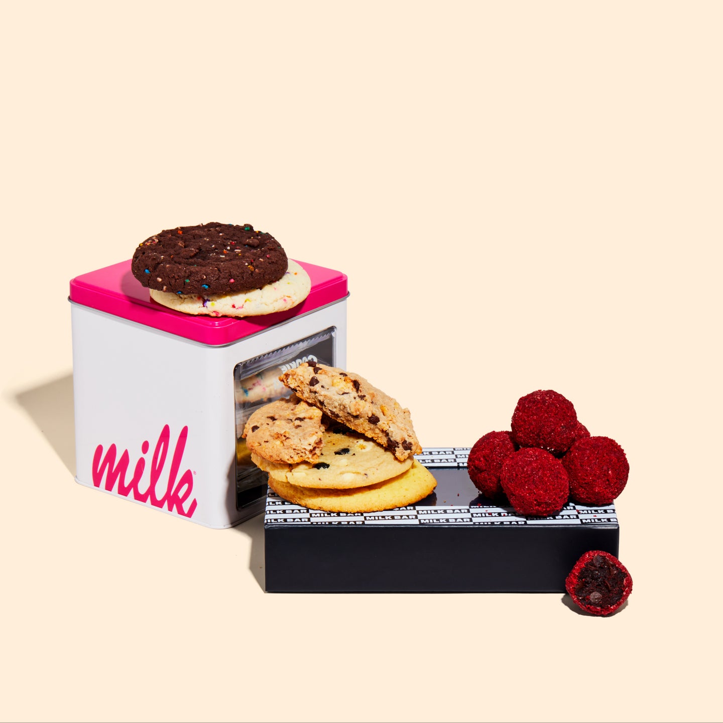 Red Velvet Cheesecake Truffle Dozen Box next to an open Assorted Cookie Tin.