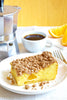 Side view of Cake-Mix Coffee Cake on a plate next to a cup of coffee