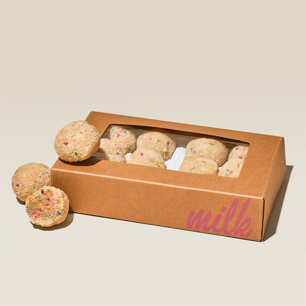 A gluten-free truffle dozen box with truffles sitting on top of the box.
