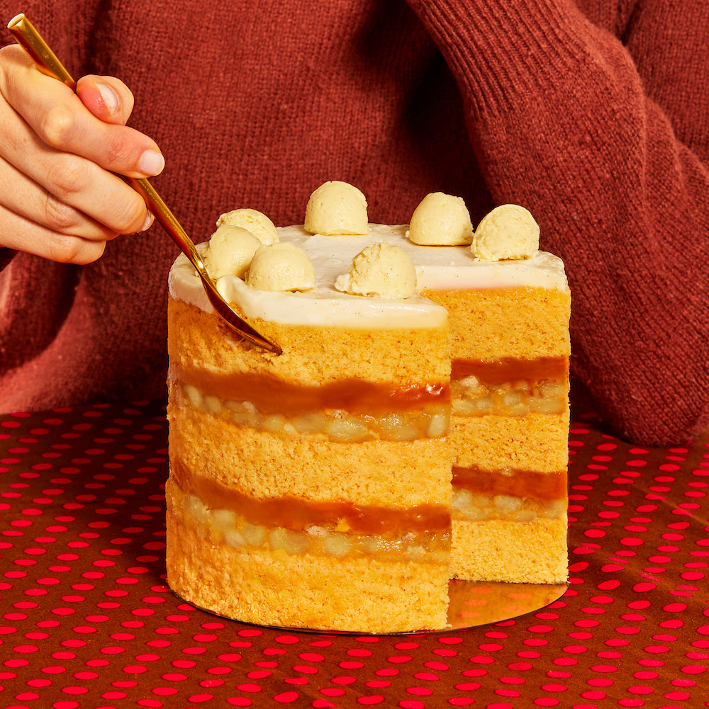 A person digging out a bite of the new caramel apple pie cake with a utensil. 