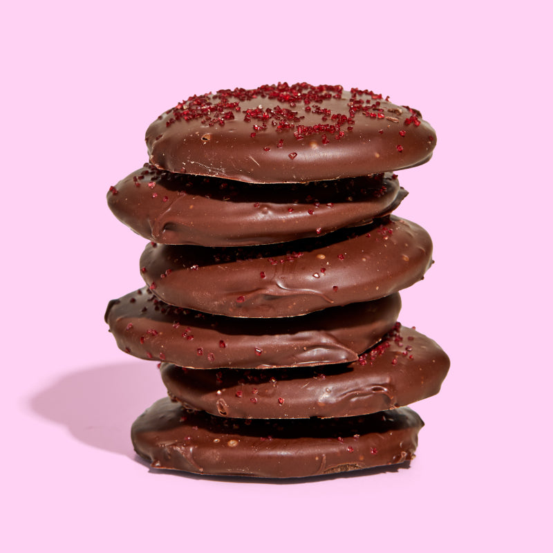 A side view of a stack of 6  limited-edition chocolate covered strawberry snap cookies