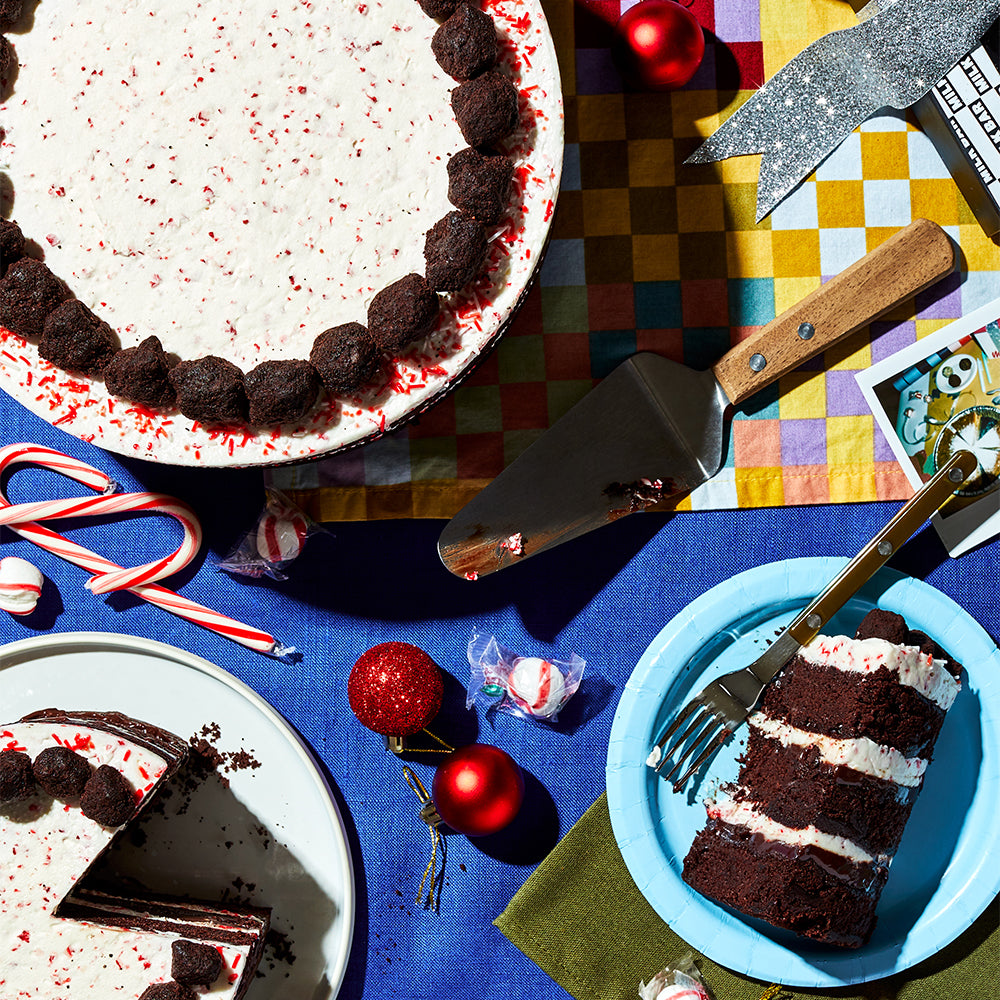 overhead view of the 10 inch and 6 inch peppermint bark cakes on a festive holiday dessert table.