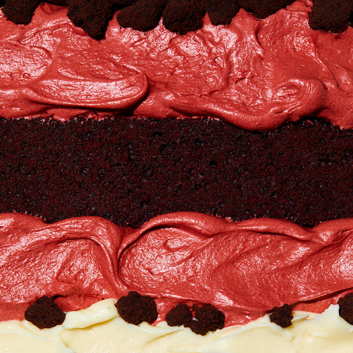macro shot of all the layers and fillings in the red velvet cheesecake cake.