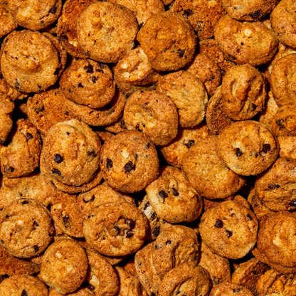 overhead macro view of a large pile of brown butter chocolate chip super crunchy cookies