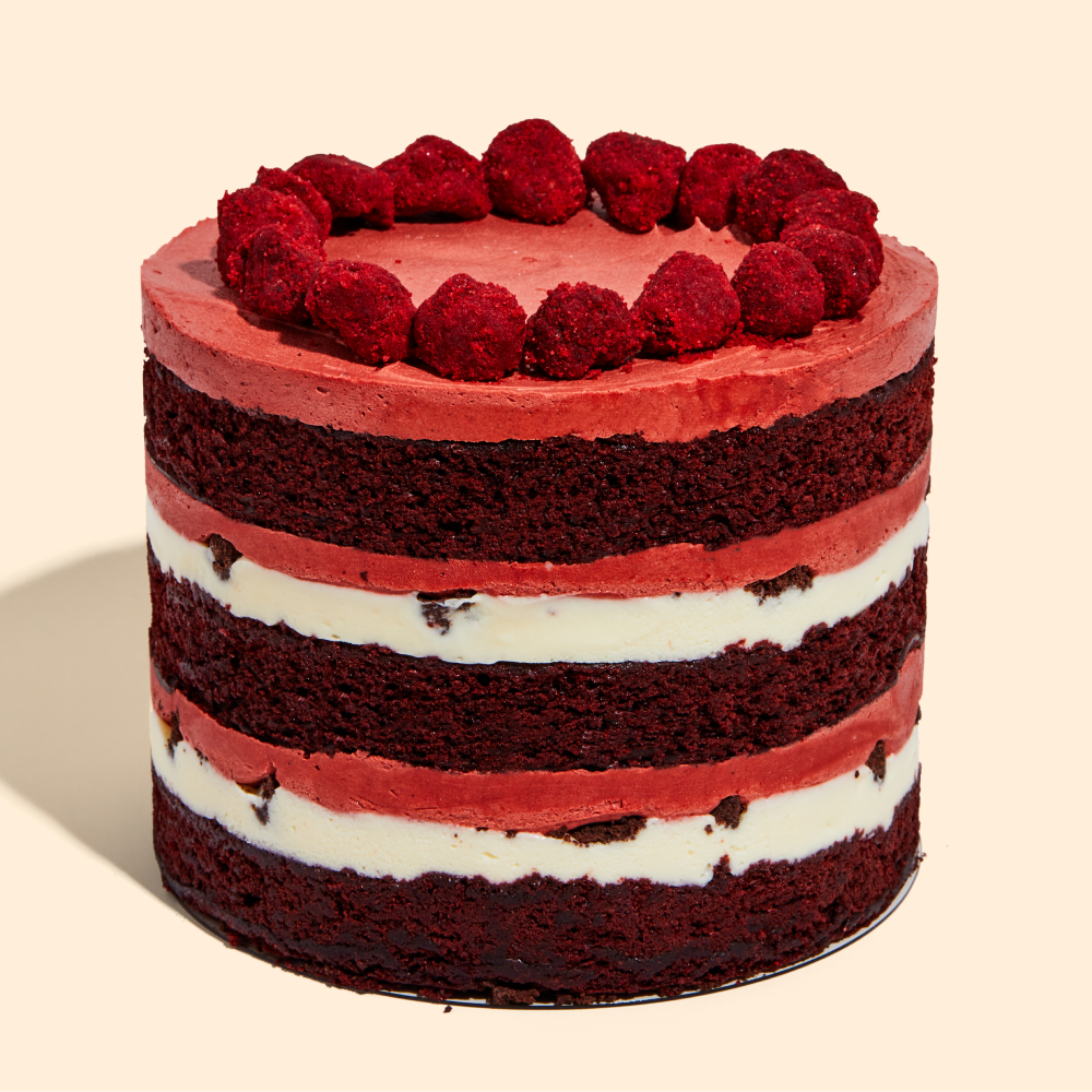Side shot of the 6" Red Velvet Cheesecake Cake, displaying all the frostings and fillings.